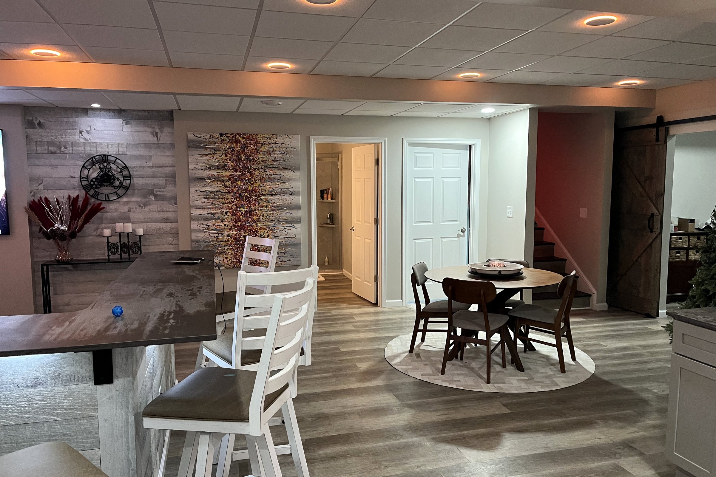 Finished basement entertainment room with fireplace and seating